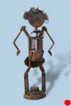 rusted metal sculpture resembling irritated woman